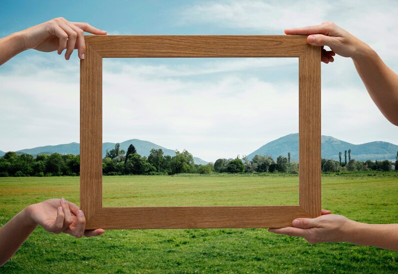 nature-landscape-with-hand-holding-frame_23-2149389988